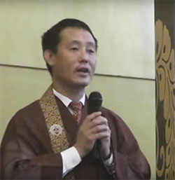 Rev. Sonam Bhutia with mic (video capture)