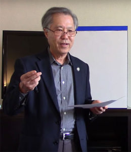Rev. Kenneth Tanaka speaking and gesturing